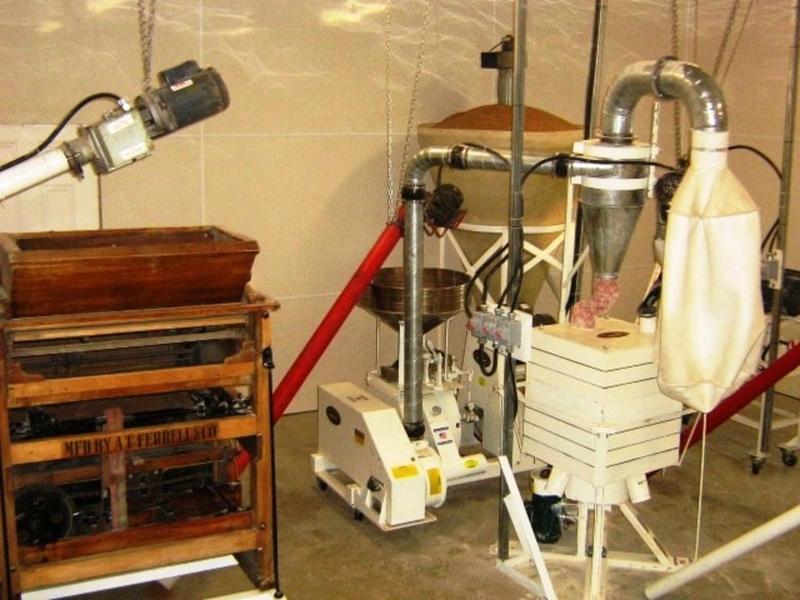 <p>The Milling Process</p>
<p>Step 1:<br />
Grain is augured inside from the outdoor bins. The grain is cleaned using a screen air cleaner.</p>
<p>Step 2:<br />
The now clean grain is stored in a hopper inside to bring the grain to room temperature and to the proper moisture level.</p>
<p>Step 3:<br />
Once dry, the grain goes into the first stone mill which has two 20 inch pink granite stones. One stone stays stationary while the other slowly spins.</p>
<p>Step 4:<br />
Once milled the first time, the flour is blown into the sifter. The sifter is composed of several screens that vibrate. To make a whole wheat flour, coarser screens are used in the sifter. For a sifted flour, finer screens are used.</p>
<p>Step 5:<br />
Flour that is not yet quite fine enough is augured into a smaller mill which has two 12 inch pink granite stones. Once milled a second time, it is sent back into the sifter.</p>
<p>Step 6:<br />
Once the milling is done, the flour is augured into a hopper where it is bagged.</p>
