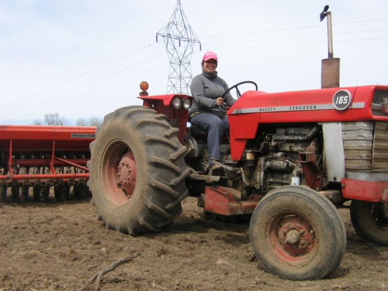 <p>Spring seeding is so busy we usually forget to take a picture or two. This here is a rare seeding picture of Andrea ready to plant barley.</p>